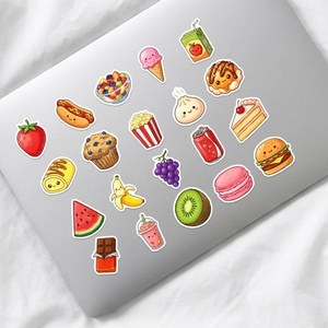 Detailed view of cute food stickers applied on a silver laptop with various kawaii designs