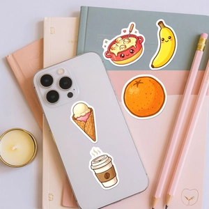 Close-up of cute cartoon food stickers including ice cream and coffee on notebooks