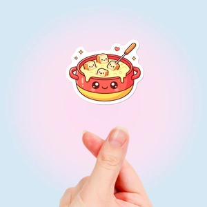 Close-up of cute cartoon food sticker showing cheese fondue pot and bread with heart gesture