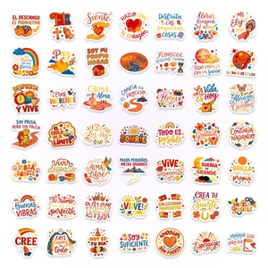 Flat lay showing 50 pieces of colorful Spanish motivational cartoon stickers for journaling