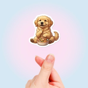 Close-up of cute golden puppy sticker held by hand to show size and cartoon detail