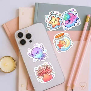 Cute macaron-colored sea creature stickers decorating a smartphone and journal