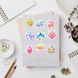 Close-up of cute cartoon ocean stickers on a stationery notebook for scrapbooking