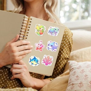 Close-up of cute cartoon ocean animal stickers used on a notebook for decoration