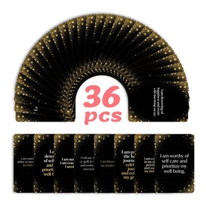 Detailed fan-out display of 36 black and gold affirmation cards with celestial patterns