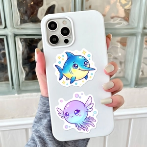 Close-up of cute cartoon ocean stickers on a white silicone smartphone case