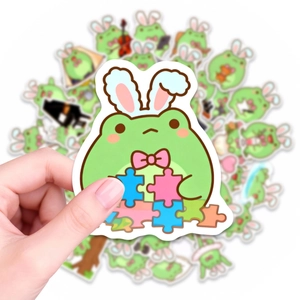 Dettaglio di un simpatico adesivo rana con orecchie da coniglio per scrapbooking e fai-da-te