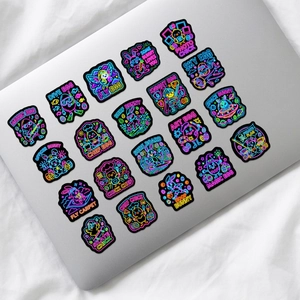 Vibrant neon cartoon animal stickers applied on a silver laptop for DIY decoration