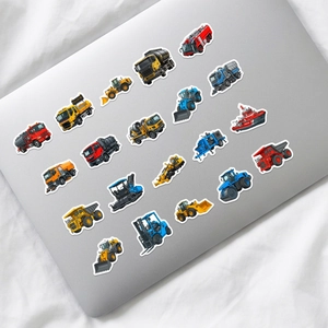 Close-up of colorful cartoon construction vehicle stickers on a laptop lid