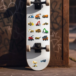 Close-up of colorful cartoon construction vehicle stickers applied on a white skateboard