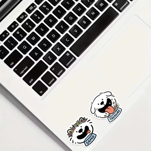 Close-up of cute cartoon Samoyed stickers on white laptop showing Sammo and Treasure motifs