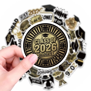 Detailed view of Class of 2026 graduation stickers in black and gold party design