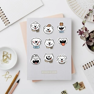 Flat lay of cute cartoon dog stickers with stationery on a white desktop surface