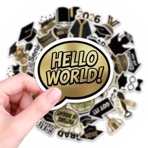 Detail showing hand holding a graduation sticker with black and gold waterproof finish