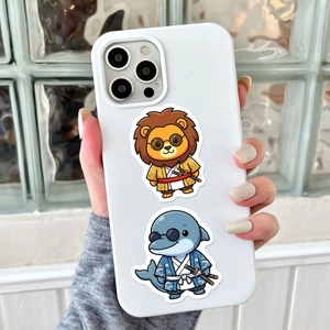 Close-up of a white phone case featuring samurai lion and dolphin cartoon stickers