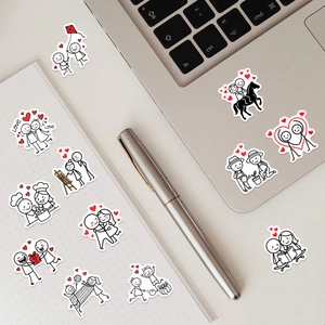 Detailed view of couple stickers with romantic hand-drawn scenes on a laptop and notebook