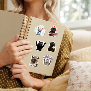 Funny cat stickers set shown on a notebook cover with cute cat meme illustrations