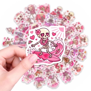 Pink waterproof vinyl sticker featuring a cartoon skull surfing on a heart-shaped board