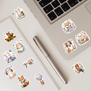 Detail of cute watercolor animal stickers on a laptop and notebook for decoration
