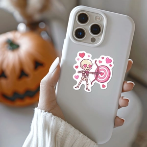 Close-up of a pink heart-eyed skeleton archer sticker on a white iPhone case
