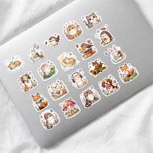 Cute cartoon animal stickers on a silver laptop showing various pet illustrations