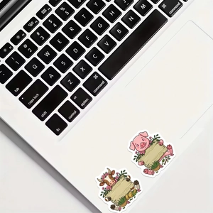 Cute pig and cow cartoon animal stickers on a white laptop with blank wooden signs
