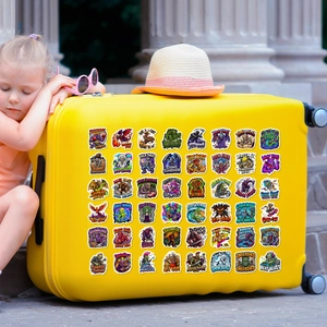 Detailed view of colorful cartoon monster stickers on a yellow suitcase with a girl