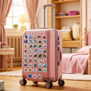 Ethnic animal stickers with mandala patterns applied on a pink travel suitcase surface