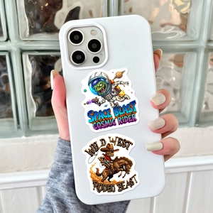 Detail of cute monster stickers on a white phone case featuring space and rodeo themes