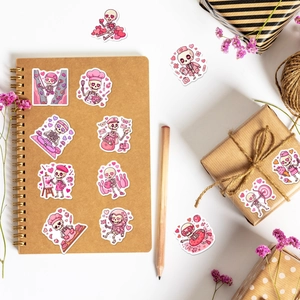 50pcs Pink Valentine Skeleton Stickers collection displayed on a notebook and gift box