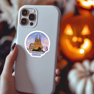 Detail of a round Barcelona Nights travel sticker on a phone case with festive background