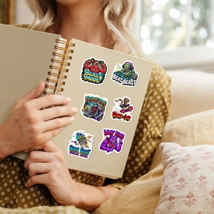 Waterproof cartoon monster stickers on a notebook cover featuring varied themes