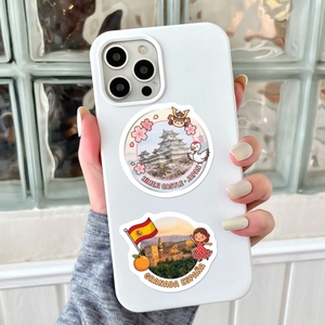 Close-up of waterproof travel stickers on a phone case featuring world landmarks