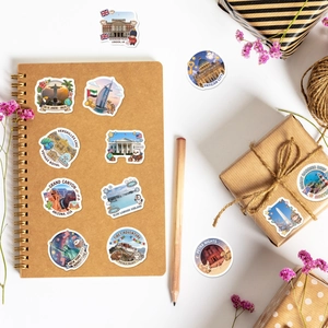 Detailed view of hand-drawn world landmark stickers on a notebook with decorative items