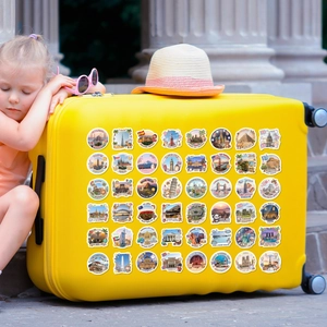 Waterproof world landmark travel stickers applied on a yellow suitcase with travel gear