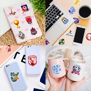 Detail showing soccer stickers applied on laptop and mug for creative decoration