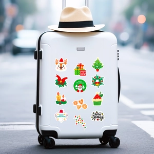 Detailed view of waterproof Christmas stickers with Santa and reindeer on a white suitcase