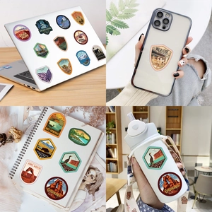 Detailed views of vintage USA National Park stickers on laptop and water bottle