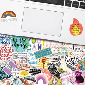 Detail of 200 inspirational English quote stickers on a laptop and flat lay display