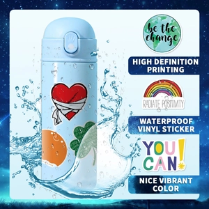 Macro shot of waterproof vinyl stickers with positive quotes on a blue water bottle