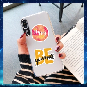 Close-up of transparent iPhone case with artistic Happy BE Yourself print design