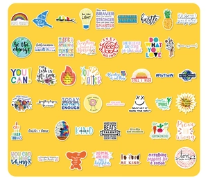 Flat lay of colorful waterproof inspirational quotes and aesthetic stickers on yellow background