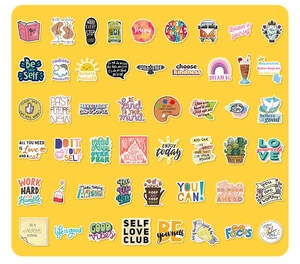 Flat lay of colorful inspirational English quote stickers on a vibrant yellow background