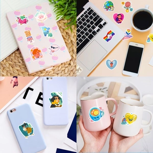 Mental health stickers on laptop and notebook featuring colorful brain and heart designs
