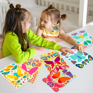 Children playing with colorful butterfly DIY sticker set for creative puzzle activities