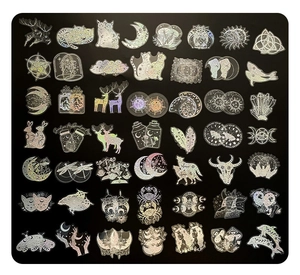 Macro view of holographic magic-themed stickers featuring lunar and mystical symbols