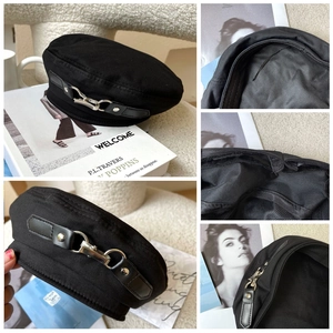 Detailed views of black flat-top beret with metal buckle and adjustable lining