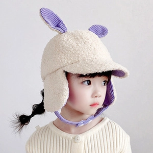 Detail of child winter hat with striped bunny ears and cream fleece ear flaps