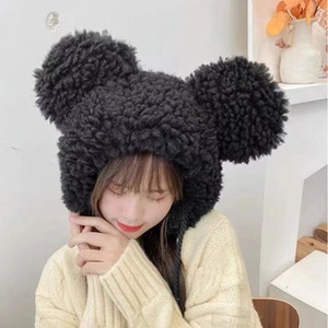 Detail of plush black faux shearling trapper hat with large round ears for women