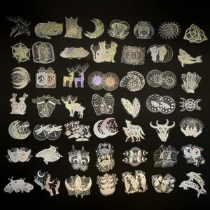 Flat lay of diverse holographic laser stickers with mystical and nature motifs